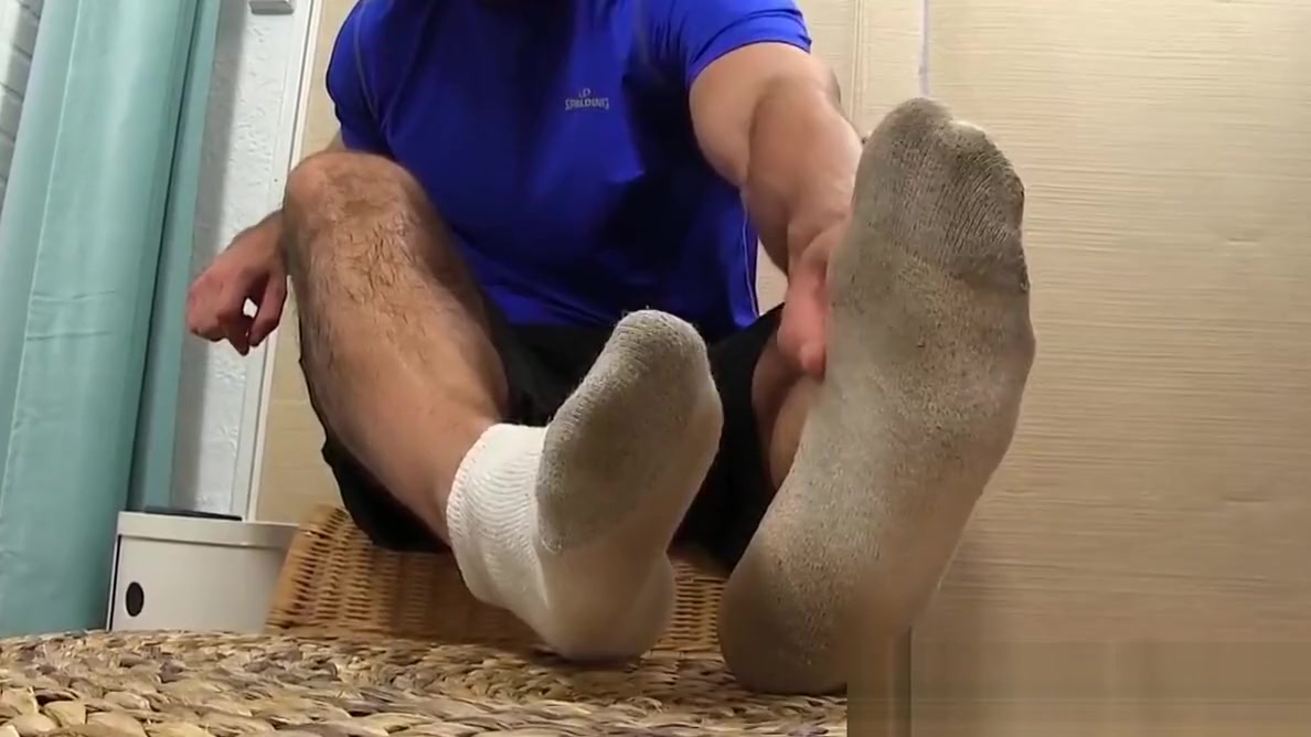 Attractive hunk plays around with feet and massages them