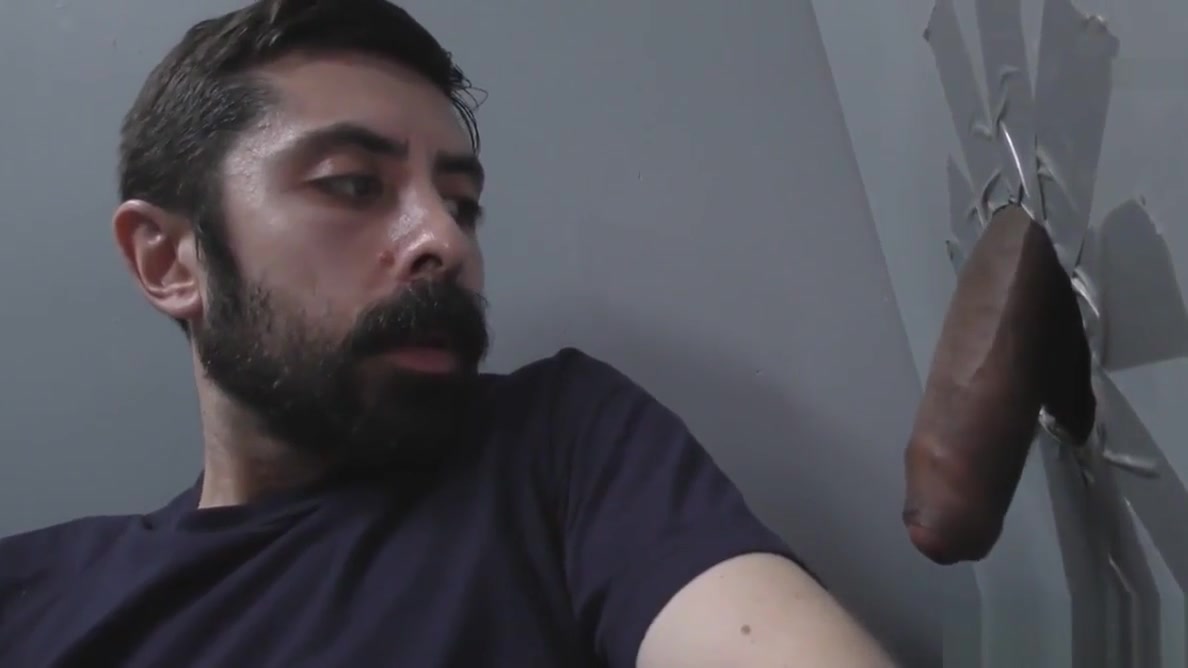 White man sucking and fucking a black cock at a gloryhole