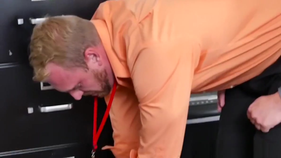 Muscular stud pounds bloke on office desk