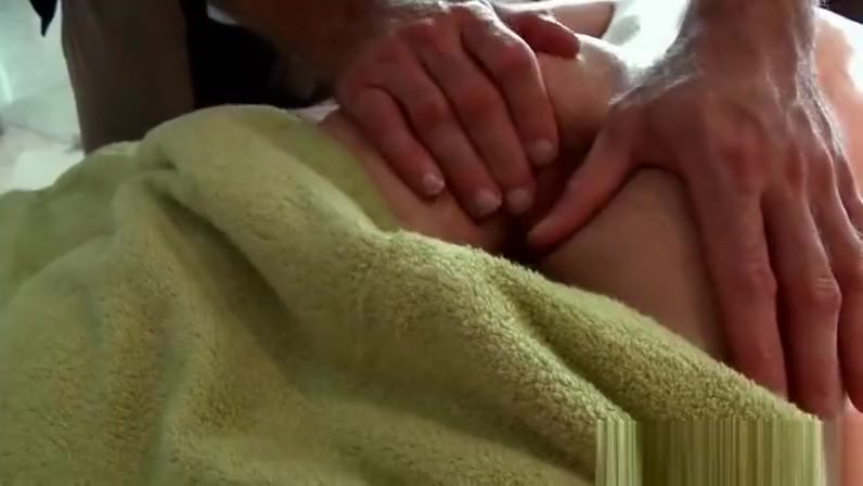 Gay masseur giving oil body massage to hot guy