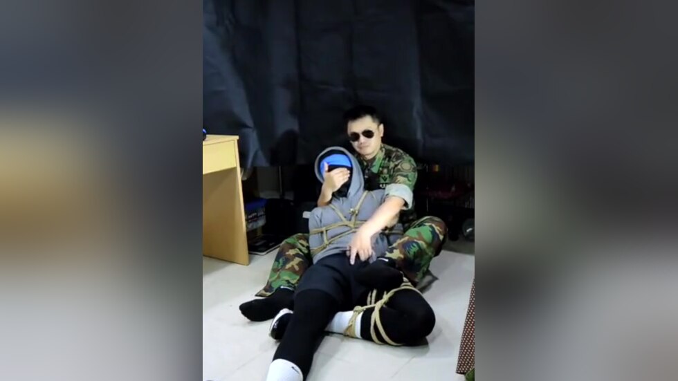 Military man gags boy with his sock