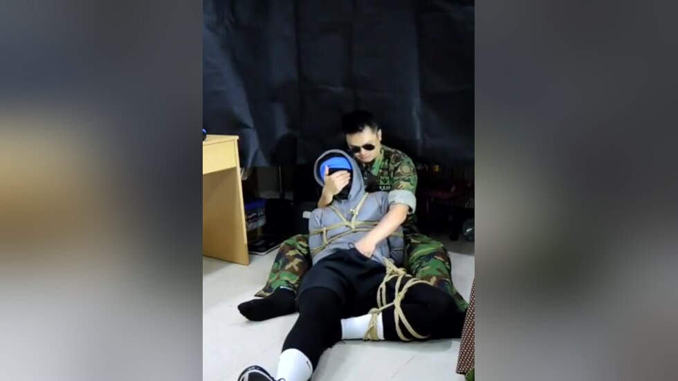Military man gags boy with his sock