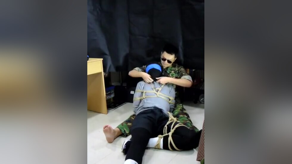 Military man gags boy with his sock