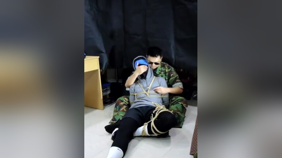 Military man gags boy with his sock
