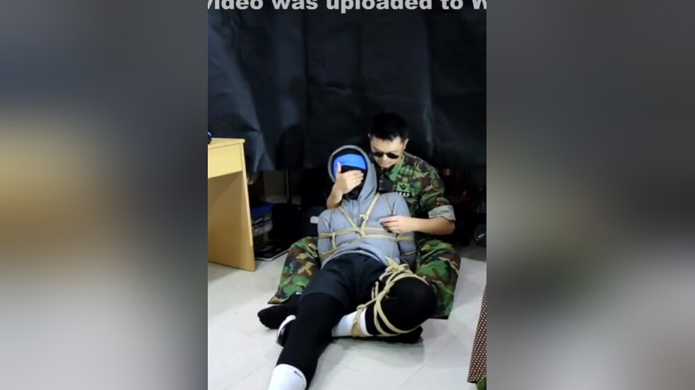 Military man gags boy with his sock