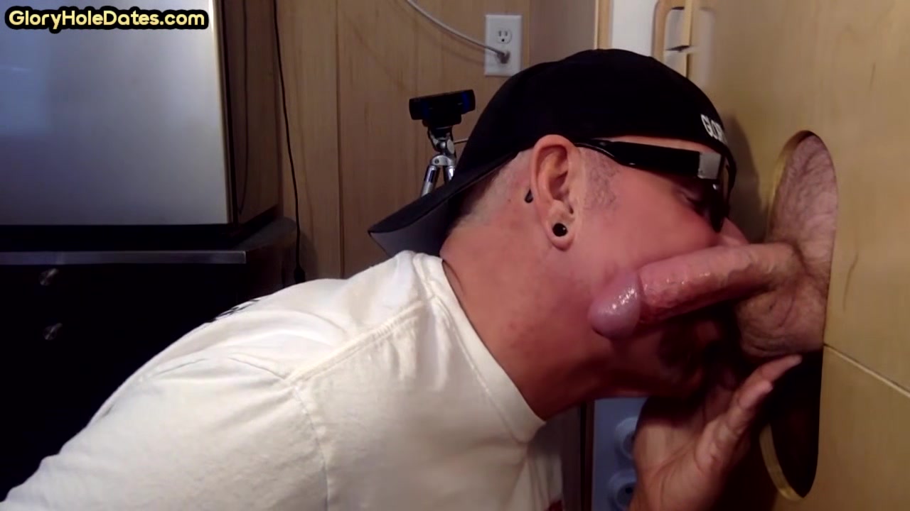 Homemade DILF sucks ands wanks penis through gloryhole