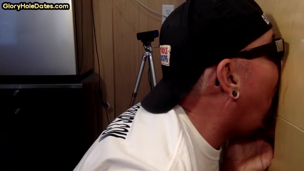 Homemade DILF sucks ands wanks penis through gloryhole