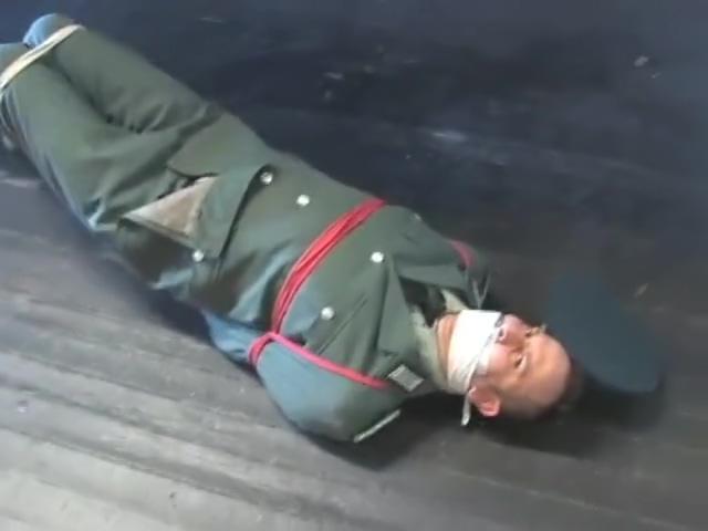 BG Military officer trussed up and gagged.