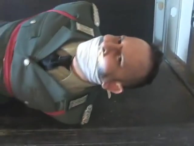 BG Military officer trussed up and gagged.