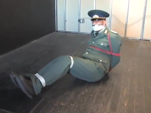 BG Military officer trussed up and gagged.