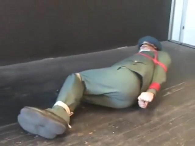 BG Military officer trussed up and gagged.