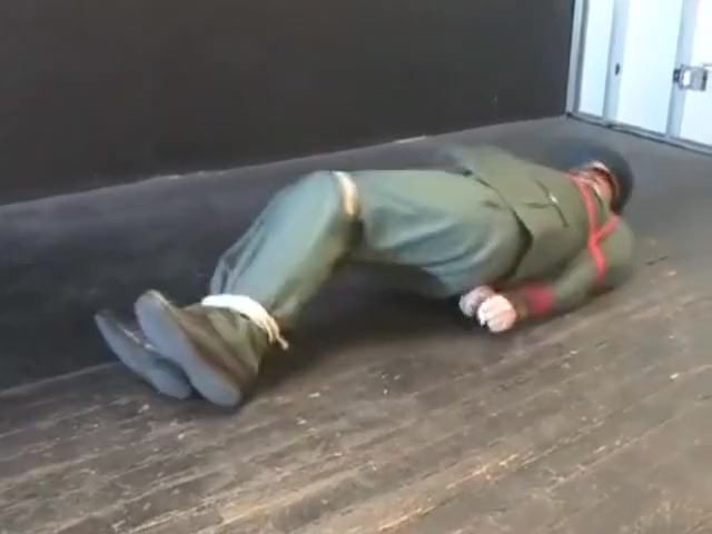 BG Military officer trussed up and gagged.