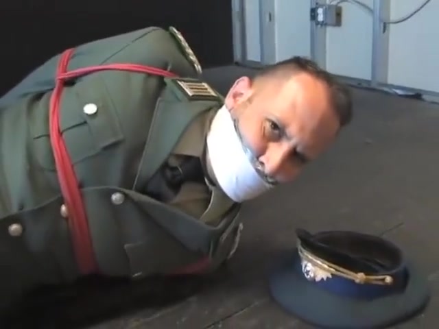 BG Military officer trussed up and gagged.