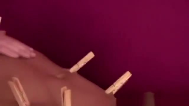 Kinky gay slave fastened with pegs