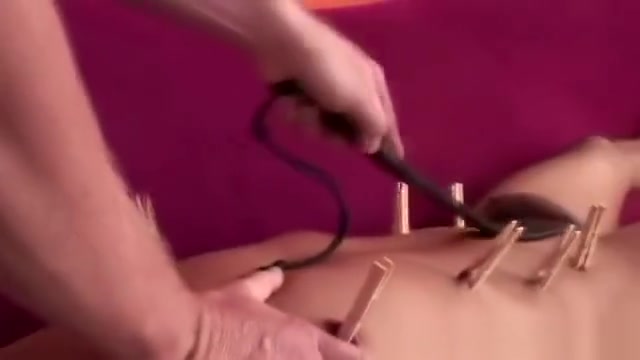 Kinky gay slave fastened with pegs