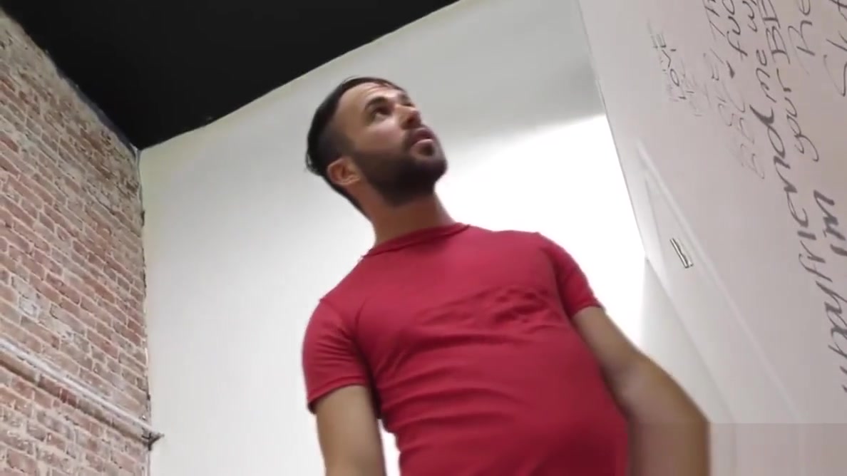 Bearded guy sucking off a black cock at a gloryhole