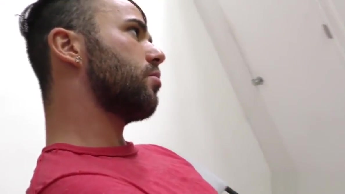 Bearded guy sucking off a black cock at a gloryhole