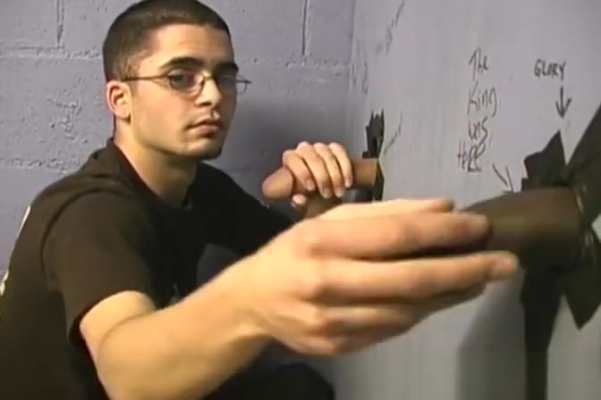 Thin gay white guy sucking off black cocks at a gloryhole