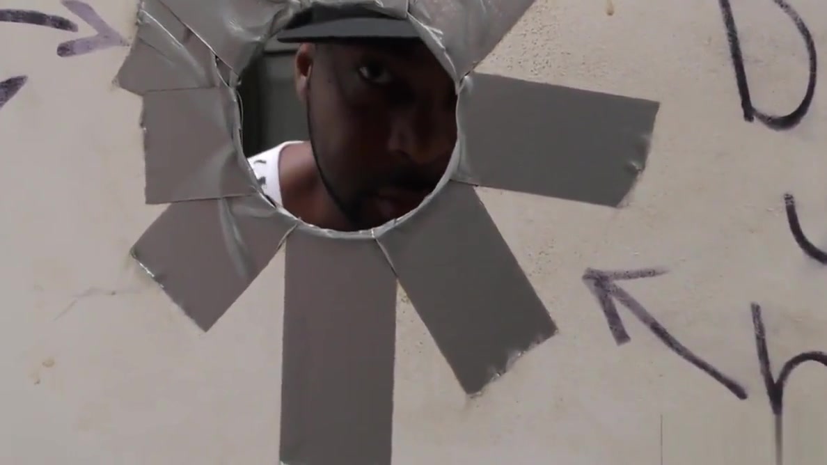 Bearded guy sucking off a black cock at a gloryhole