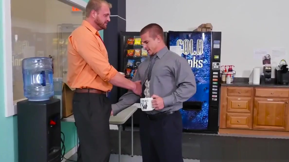 Muscular stud pounds bloke on office desk