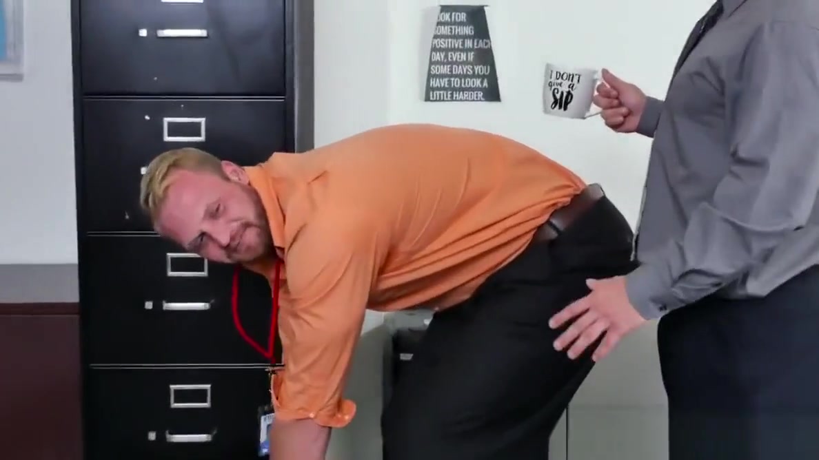 Muscular stud pounds bloke on office desk