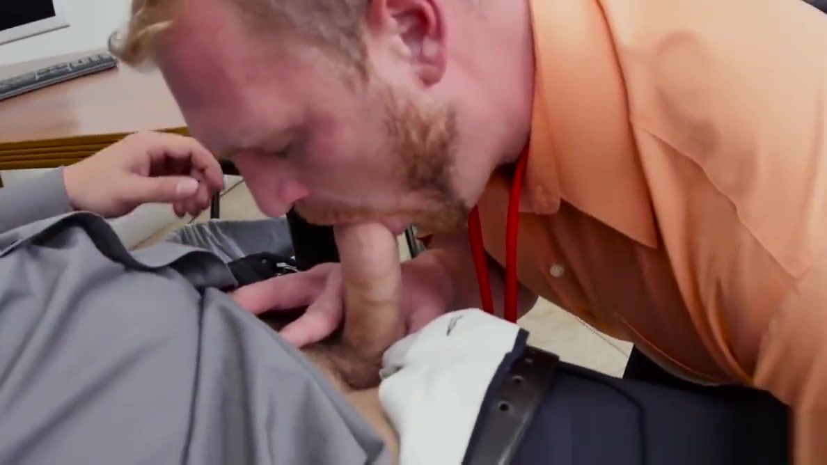 Muscular stud pounds bloke on office desk
