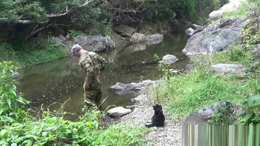 Two military lads resting by the river