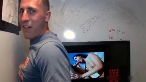 Sexy stud gets his massive white penis sucked through gloryhole