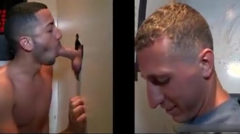 Sexy stud gets his massive white penis sucked through gloryhole