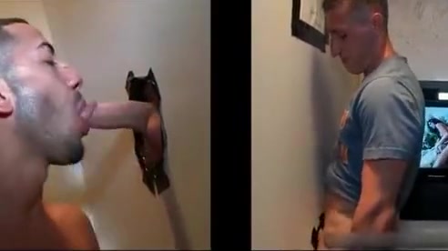 Sexy stud gets his massive white penis sucked through gloryhole