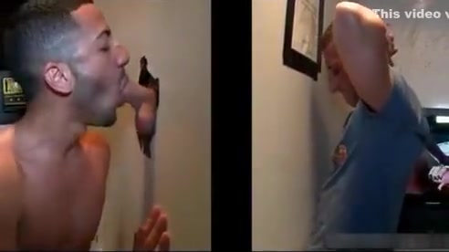 Sexy stud gets his massive white penis sucked through gloryhole