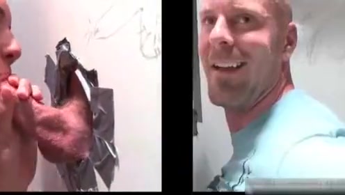 Muscled bald dude gets hot fellatio through gloryhole
