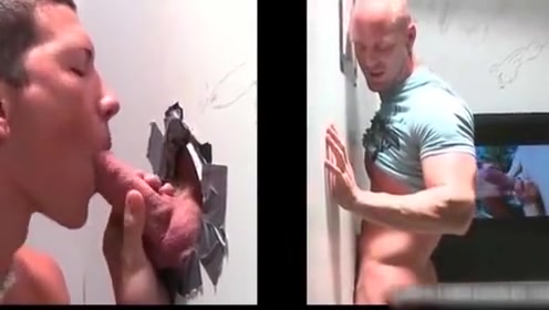 Muscled bald dude gets hot fellatio through gloryhole