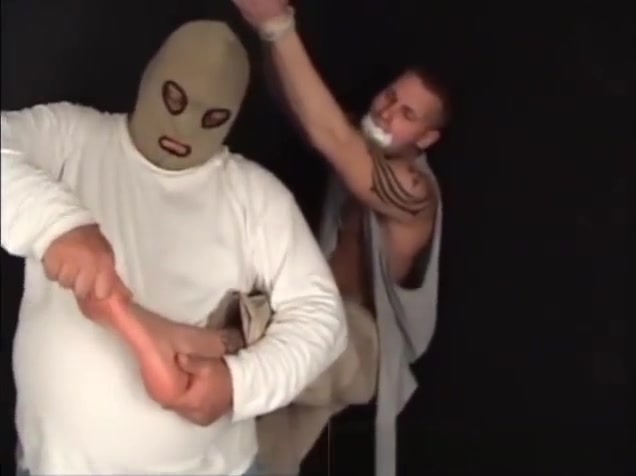 Handsome ex-military stud strung up by hs wrists gagged and stripped.
