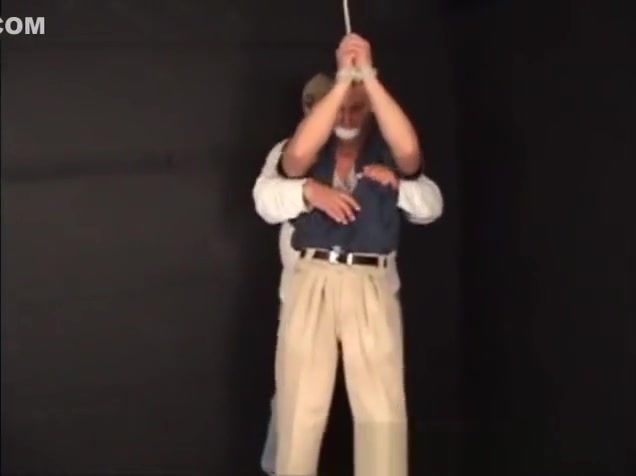 Handsome ex-military stud strung up by hs wrists gagged and stripped.