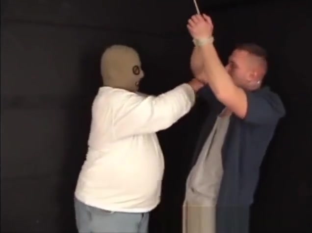 Handsome ex-military stud strung up by hs wrists gagged and stripped.