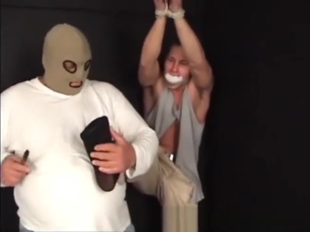 Handsome ex-military stud strung up by hs wrists gagged and stripped.