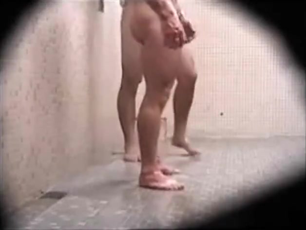 Guy gets a semi showering at gym with his bud