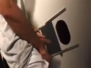Enjoying a horny cock through the gloryhole