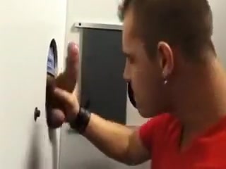 Enjoying a horny cock through the gloryhole