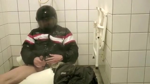 SHOWERING IN BOMBER HELMET AND PVC JACKET