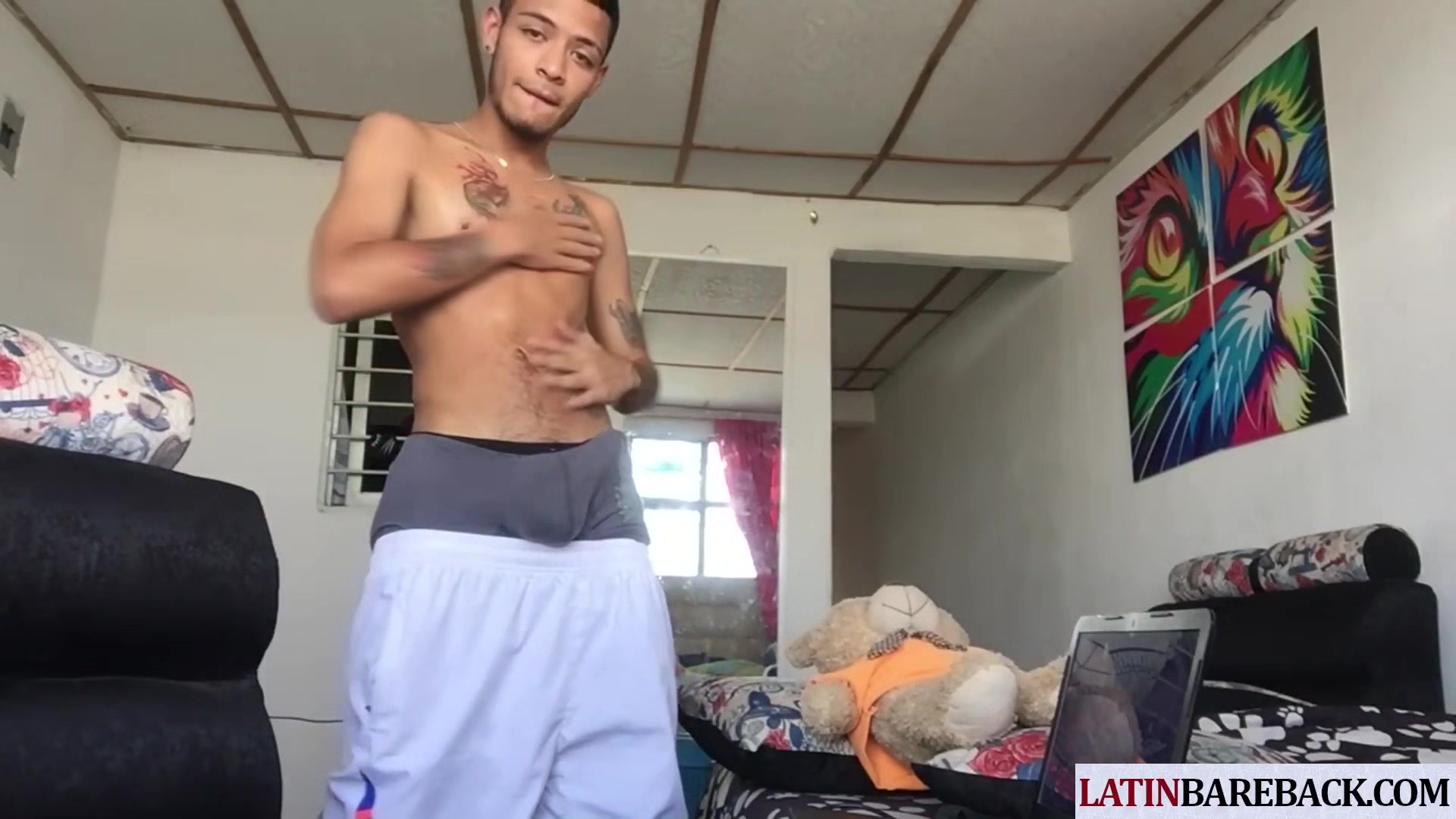 Tattooed twink latino tugging his shaved cock