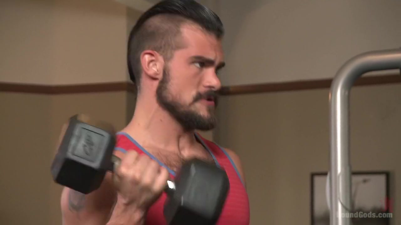 Ripped gym rat Aarin Asker takes a giant fist while in suspension