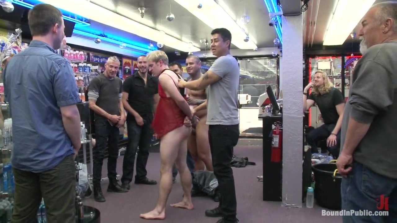 Two thugs drag a businessman into a porn shop and strip him of his manhood.