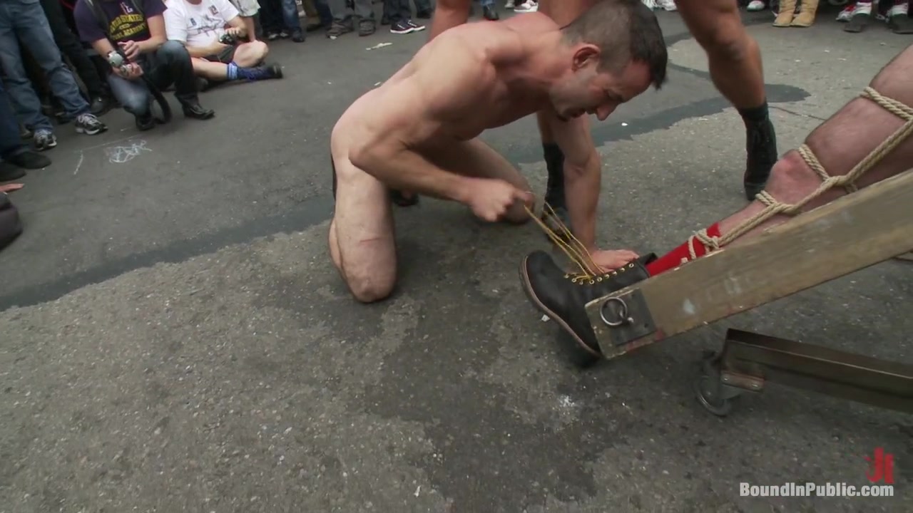 Muscle slave is stripped naked, used and humiliated while hordes of people take photos.