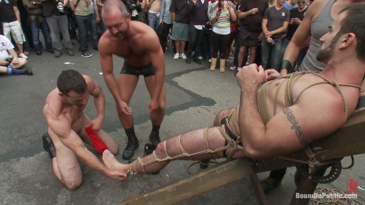 Muscle slave is stripped naked, used and humiliated while hordes of people take photos.