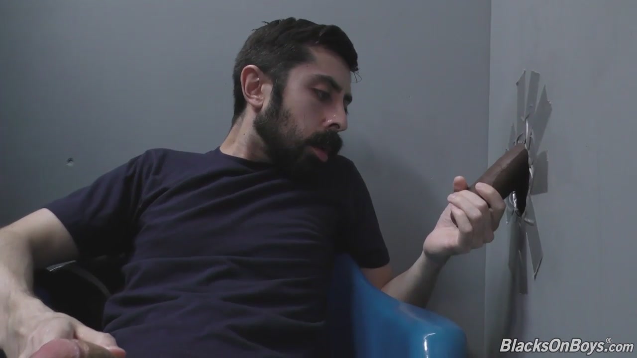 Bearded white man sucking and fucking a black cock at a gloryhole