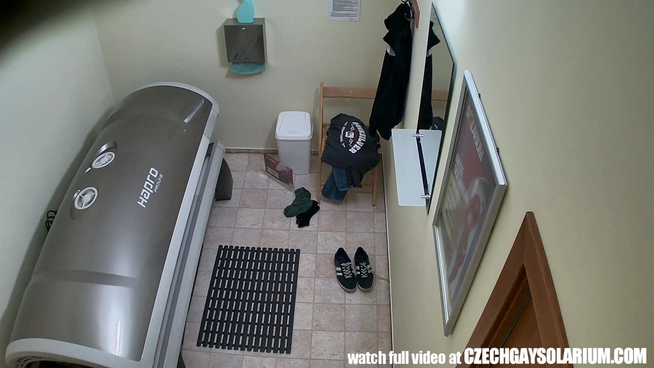 Handsome young man filmed secret camera in public solarium
