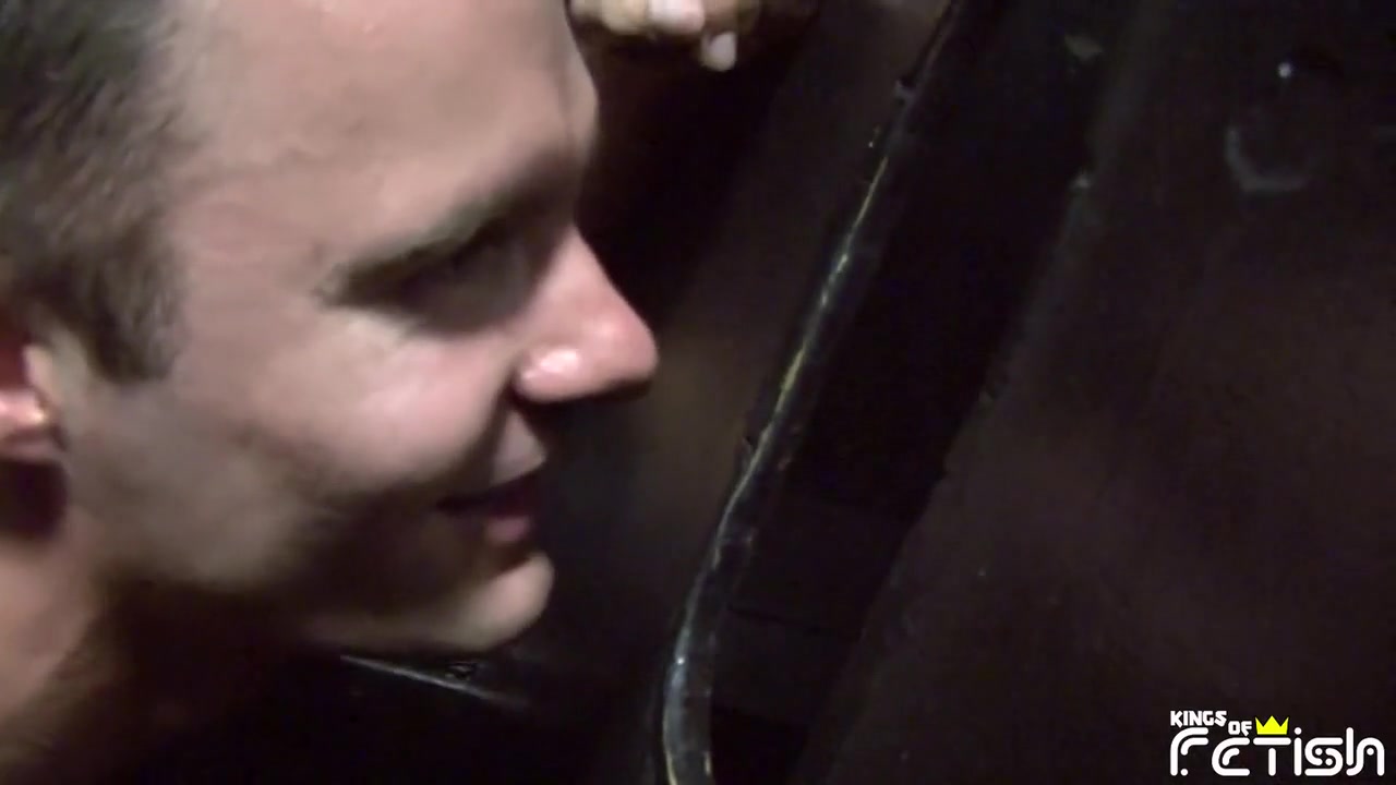 Horny brunette man sucks two big cocks trough gloryhole and gets facial cumshot