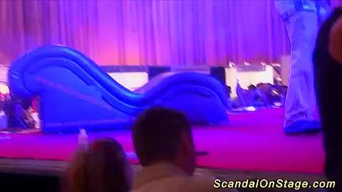 busty babe naked on public stage